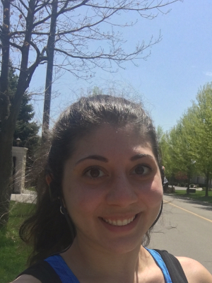 Francine smiling outside on a summer day.